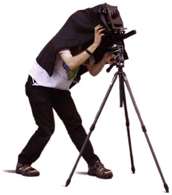 Photographer under dark cloth