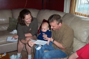 ek_11.jpg - Alexander reads the card that came with his beautiful blanket knitted by Aunt Frances.