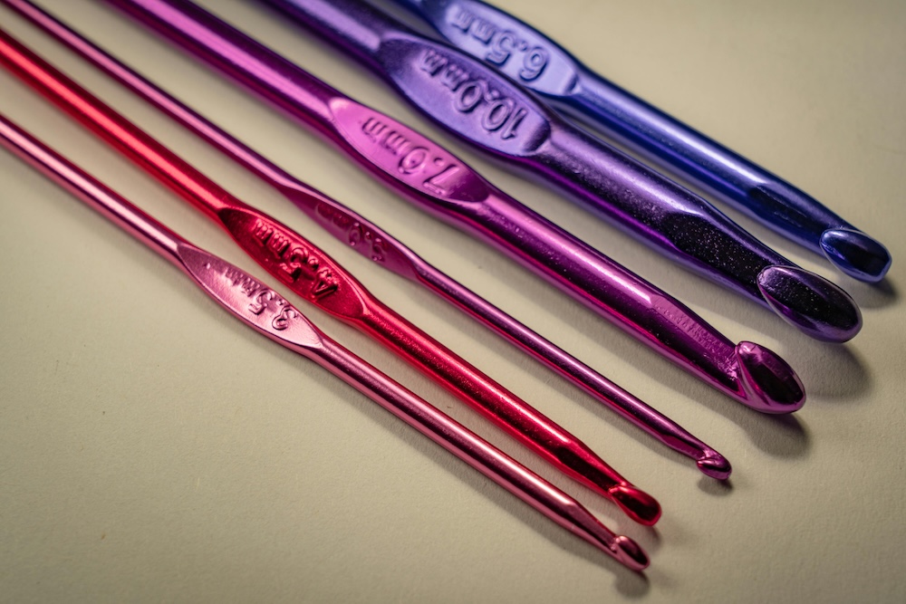 An image of six different hooks that are a gradient from pink to purple.