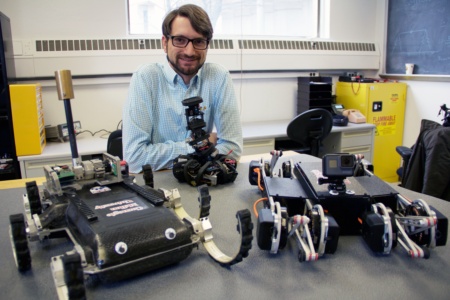 Aaron M. Johnson with some robots