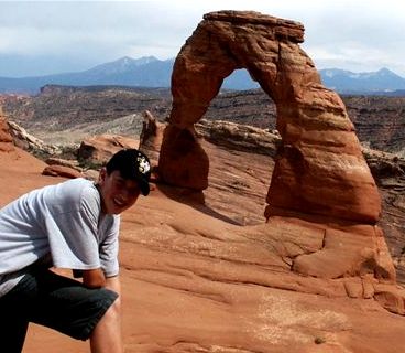 Son in front of Delicate Arch in Arches National Park