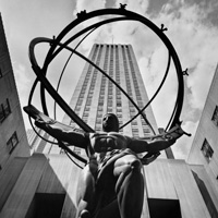 Statue of Atlas in front of a skyscraper